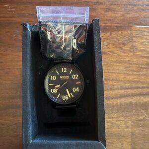 Nixon Black and Gold Dial Watch